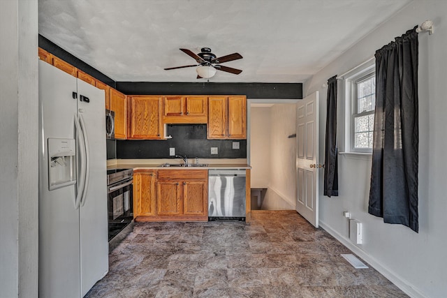 kitchen featuring ceiling fan, appliances with stainless steel finishes, and sink