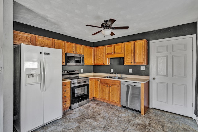 kitchen featuring ceiling fan, sink, and stainless steel appliances