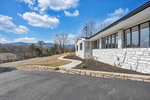 view of side of home with a mountain view