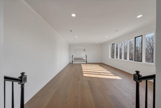 spare room with ornamental molding and hardwood / wood-style floors