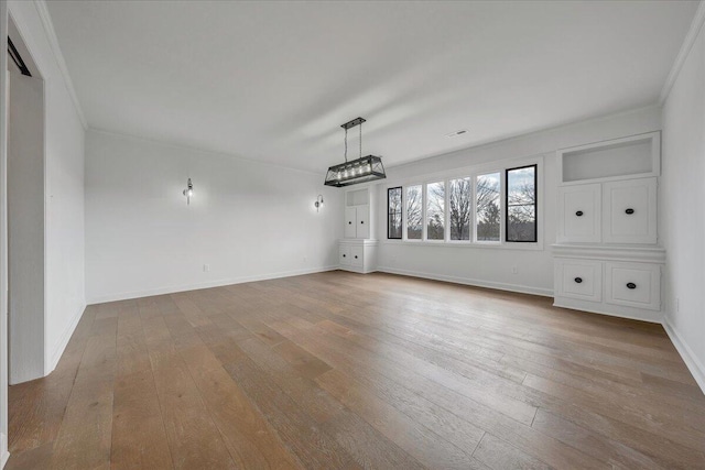 interior space featuring crown molding and light wood-type flooring