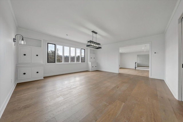 interior space with crown molding and light hardwood / wood-style flooring