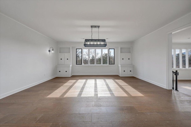 unfurnished dining area featuring hardwood / wood-style flooring and ornamental molding