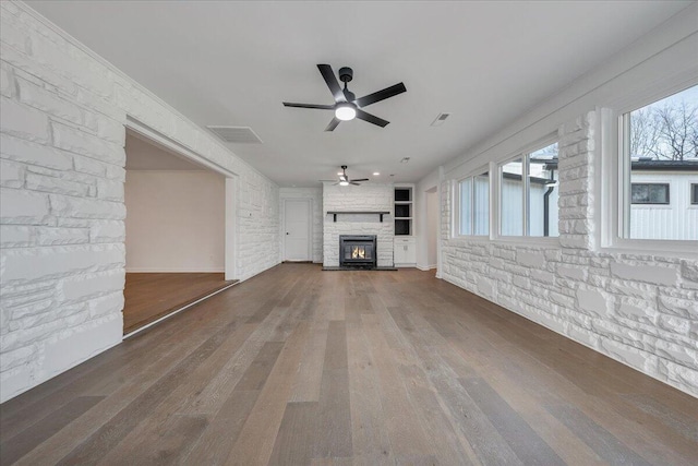 unfurnished living room featuring ceiling fan and hardwood / wood-style floors