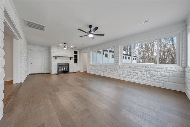 unfurnished living room with wood-type flooring and ceiling fan