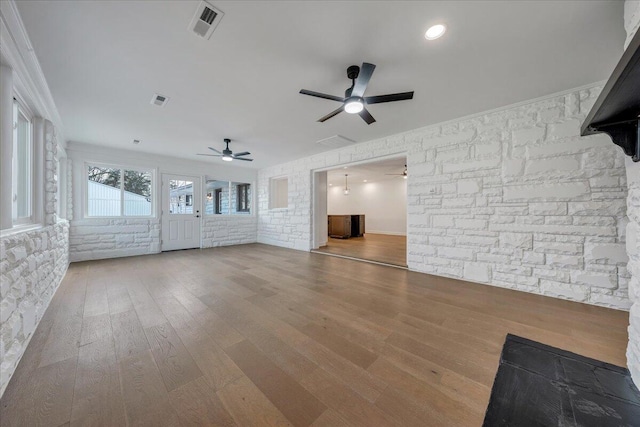 unfurnished living room with hardwood / wood-style flooring and ceiling fan