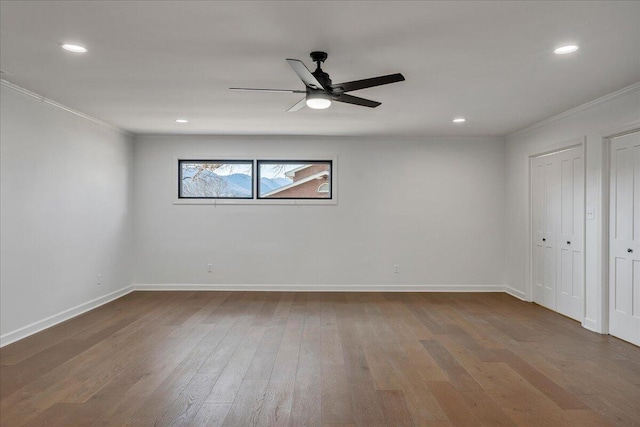 empty room with hardwood / wood-style floors, ornamental molding, and ceiling fan