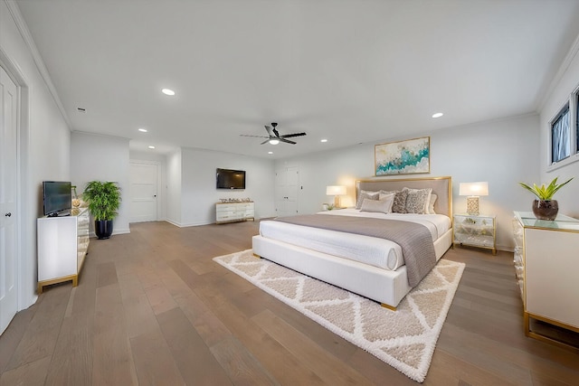 bedroom with crown molding, wood-type flooring, and ceiling fan