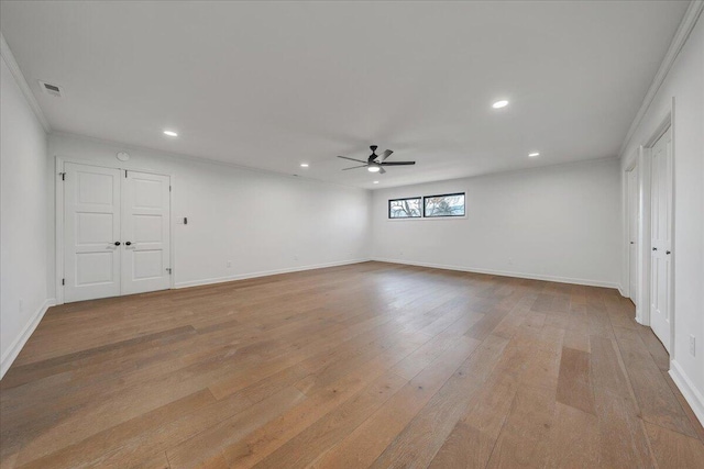 empty room featuring ceiling fan, ornamental molding, and light wood-type flooring