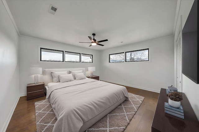 bedroom featuring crown molding, ceiling fan, and dark hardwood / wood-style floors