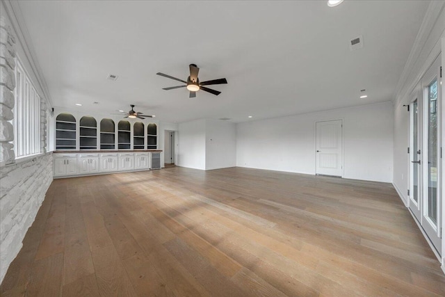 unfurnished living room featuring light hardwood / wood-style floors and ceiling fan