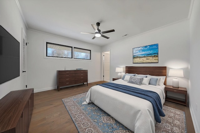 bedroom featuring hardwood / wood-style flooring, ceiling fan, and crown molding