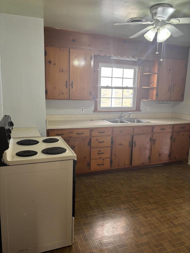 kitchen featuring a sink, electric range, open shelves, and light countertops