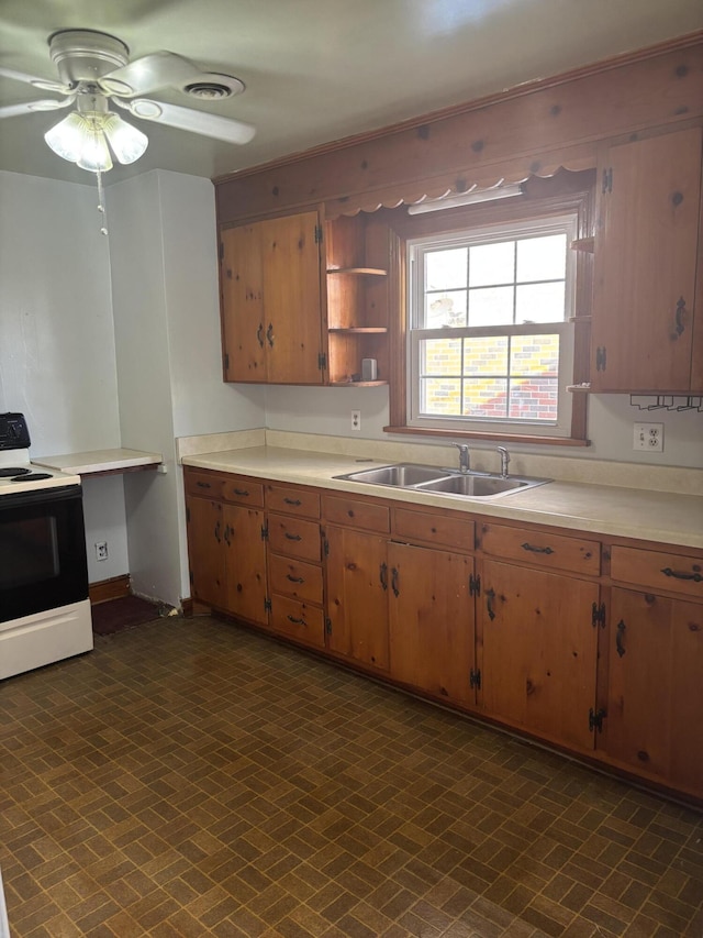 kitchen featuring a sink, light countertops, visible vents, and range with electric stovetop