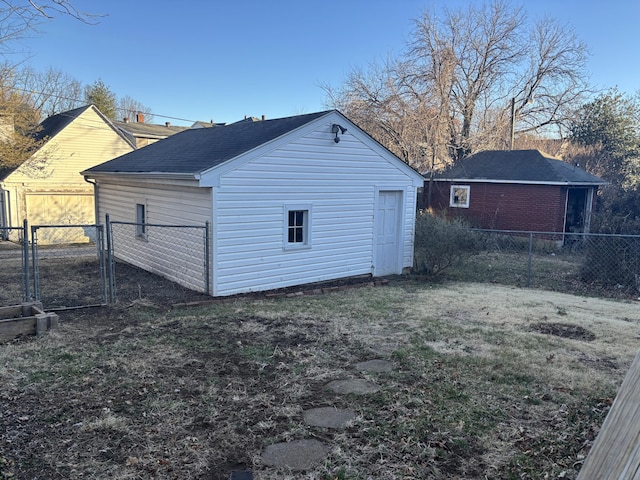 view of outbuilding with a gate and fence