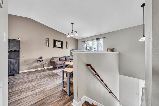 staircase featuring hardwood / wood-style floors and lofted ceiling