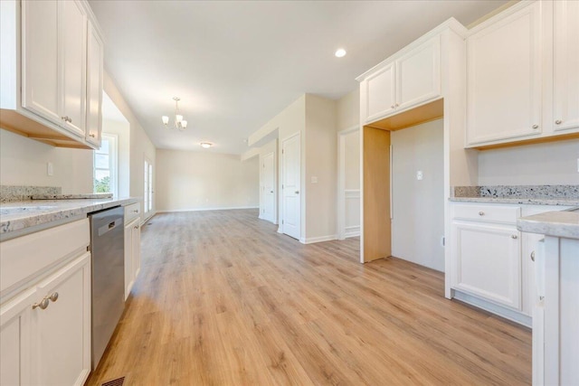 kitchen featuring white cabinets, dishwasher, and light stone countertops