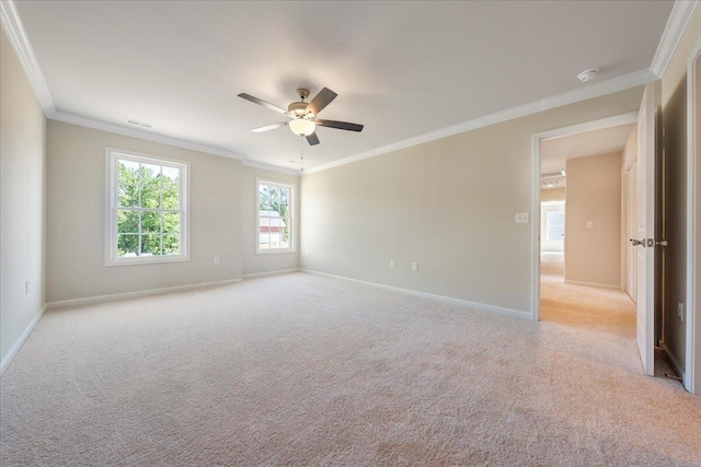 carpeted spare room with ceiling fan and crown molding