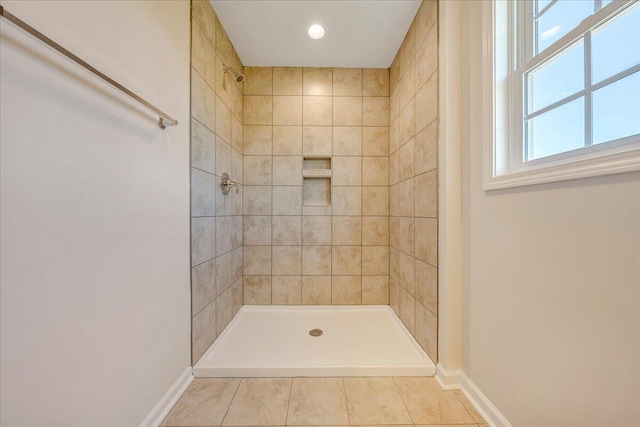 bathroom featuring tile patterned floors and tiled shower