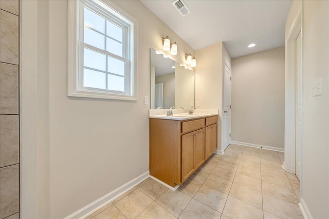 bathroom featuring tile patterned flooring and vanity