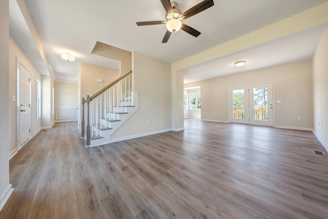 4999 Warrior Dr, Salem, VA 24153 - unfurnished living room featuring wood finished floors, a ceiling fan, visible vents, baseboards, and stairs