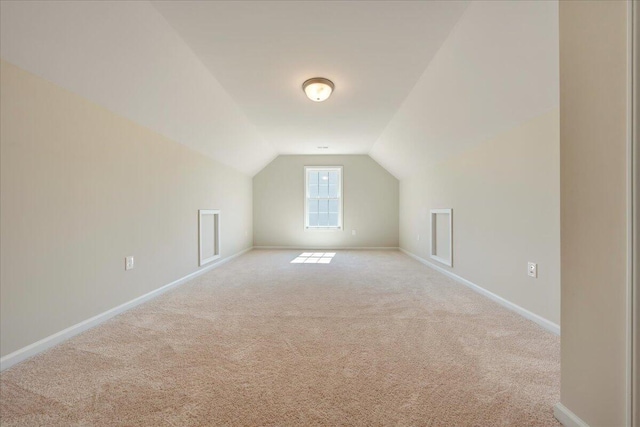 bonus room featuring light carpet and lofted ceiling