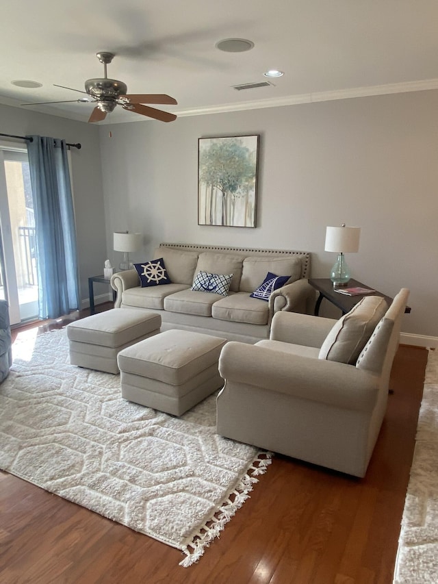 living room featuring crown molding, ceiling fan, and hardwood / wood-style flooring