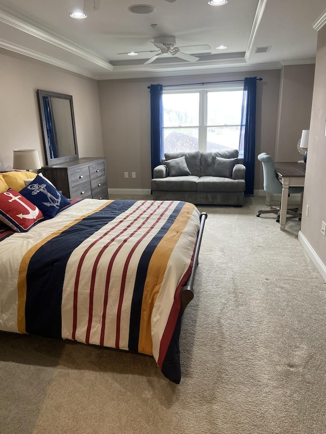 bedroom with ceiling fan, carpet floors, crown molding, and a tray ceiling