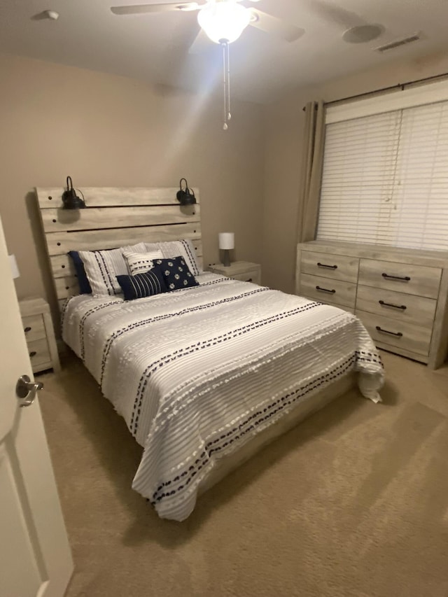 bedroom featuring dark colored carpet and ceiling fan