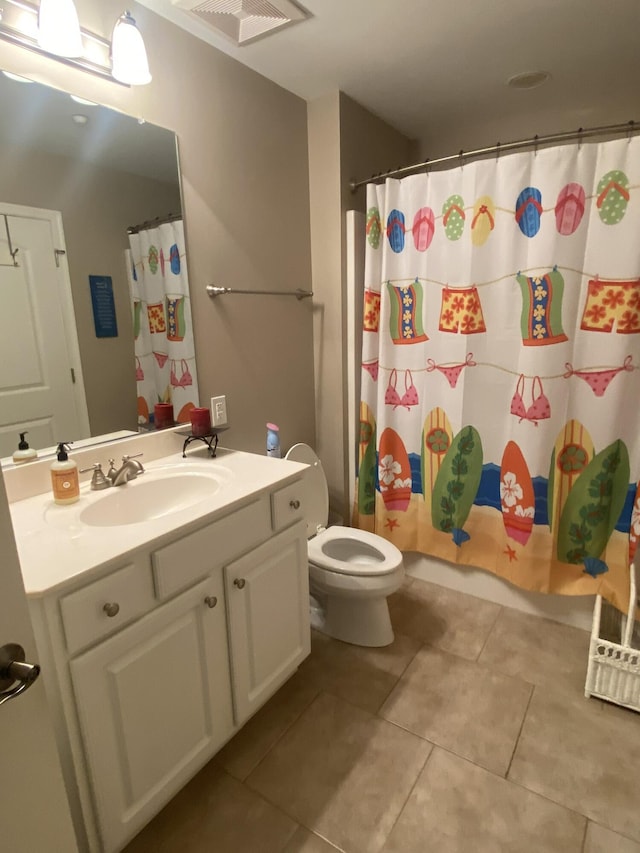 bathroom with tile patterned floors, a shower with curtain, vanity, and toilet