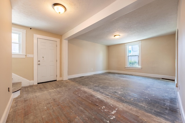 entrance foyer featuring a textured ceiling and hardwood / wood-style floors