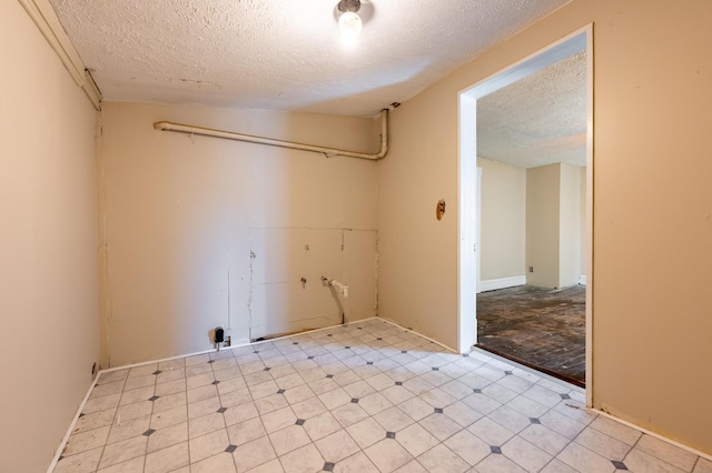 laundry area with a textured ceiling