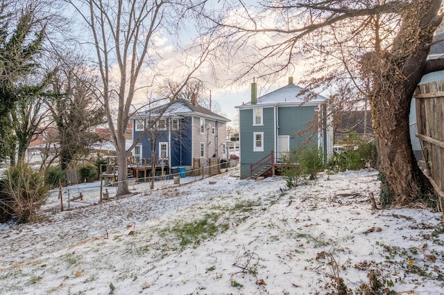 view of snow covered rear of property