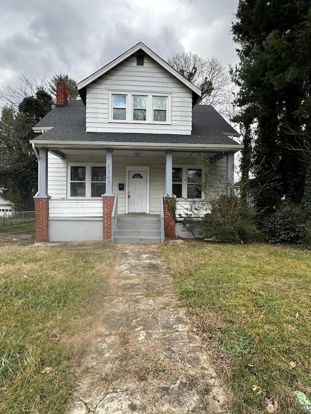 bungalow-style home featuring a front lawn