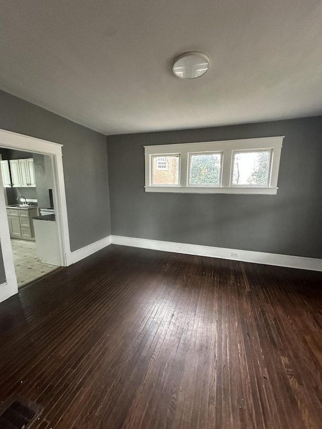 spare room featuring dark hardwood / wood-style floors