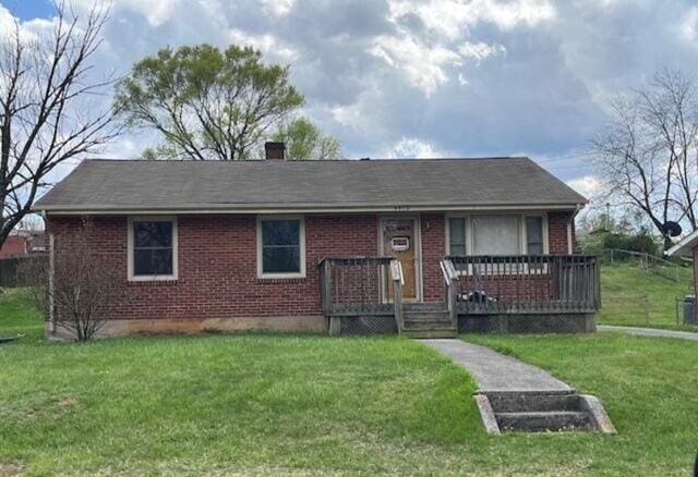 view of front of home with a deck and a front yard