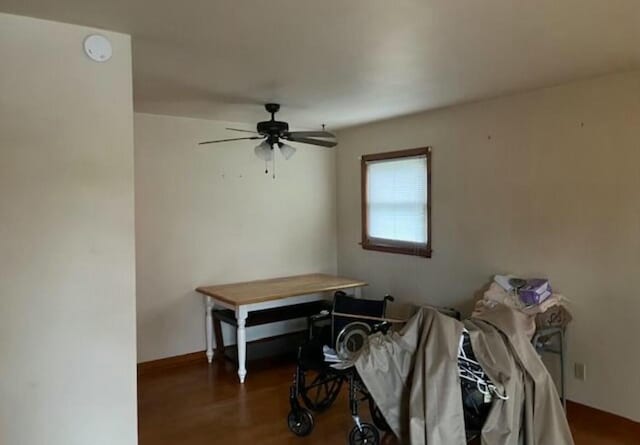 interior space featuring ceiling fan and dark wood-type flooring