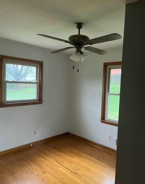 spare room featuring ceiling fan and light hardwood / wood-style flooring