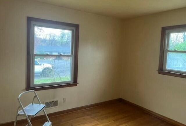 empty room with wood-type flooring