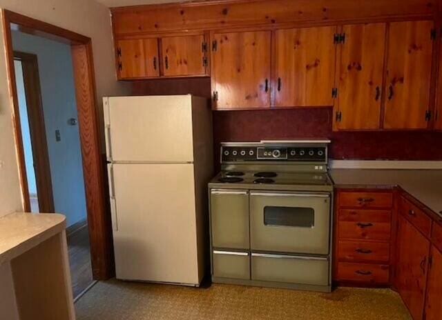 kitchen with white refrigerator and double oven range