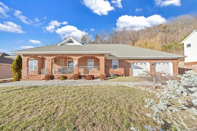 ranch-style home with covered porch, a front lawn, and a garage