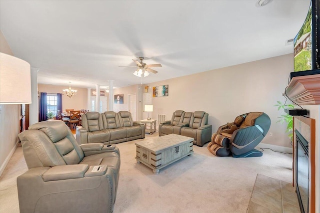 living room with ceiling fan with notable chandelier and light carpet