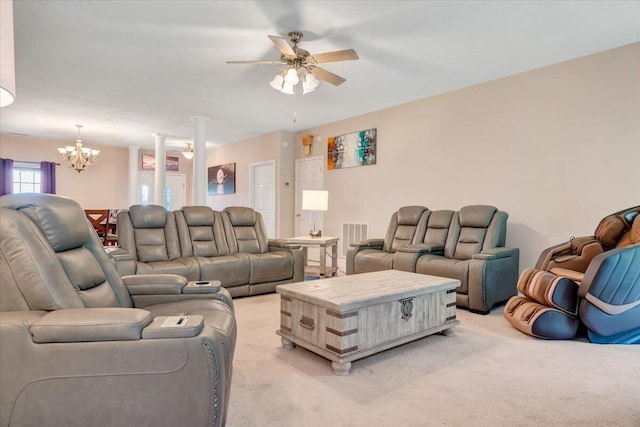 living room with ceiling fan with notable chandelier and light carpet