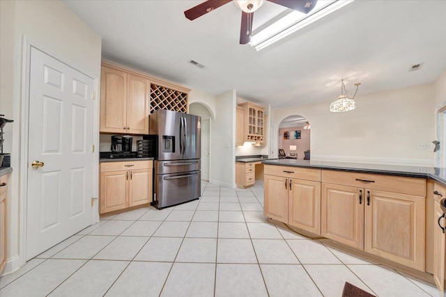 kitchen featuring ceiling fan, stainless steel fridge with ice dispenser, light brown cabinetry, and light tile patterned flooring