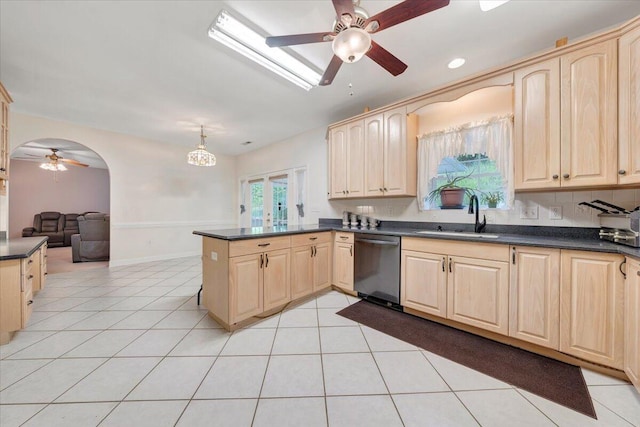 kitchen with sink, light tile patterned floors, dishwasher, and kitchen peninsula