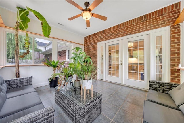 sunroom with ceiling fan and french doors