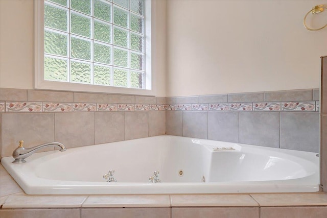 bathroom with a relaxing tiled tub