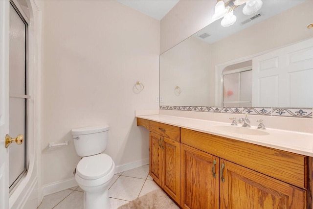 bathroom featuring vanity, tile patterned floors, and toilet