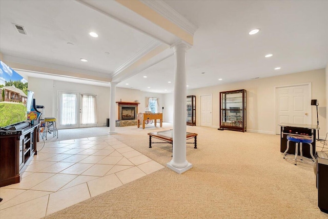 living room with ornate columns, french doors, ornamental molding, and light colored carpet