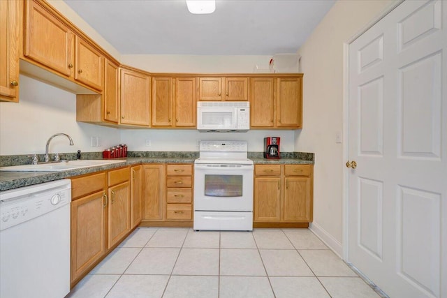 kitchen featuring white appliances, sink, and light tile patterned floors